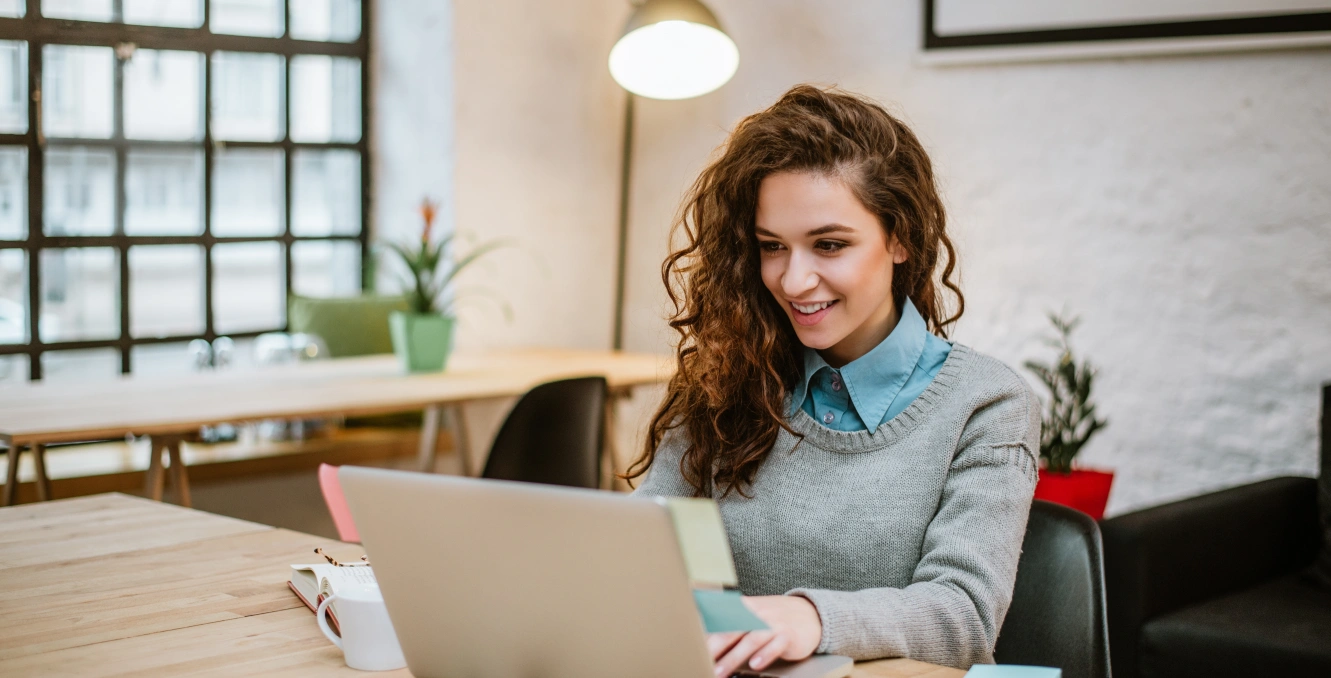 Successful young woman modern office working laptop